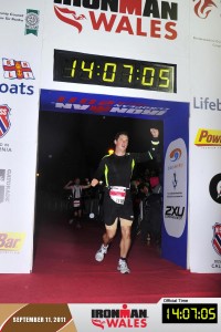 Mike Hooper crossing the finish of his first Ironman